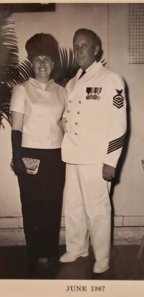 man and woman dressed for a formal night out, man in navy uniform 1967